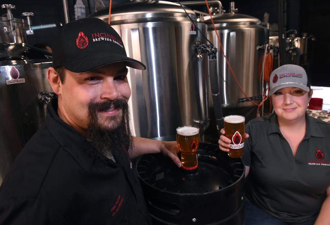 Mike Sumaya, left, and his wife Natalie Sumaya, own Incinerati Brewing Company. They brew at the incubator at 411 Broadway Ales & Spirits. Photographed Tuesday, Oct. 1, 2019 in downtown Fresno.